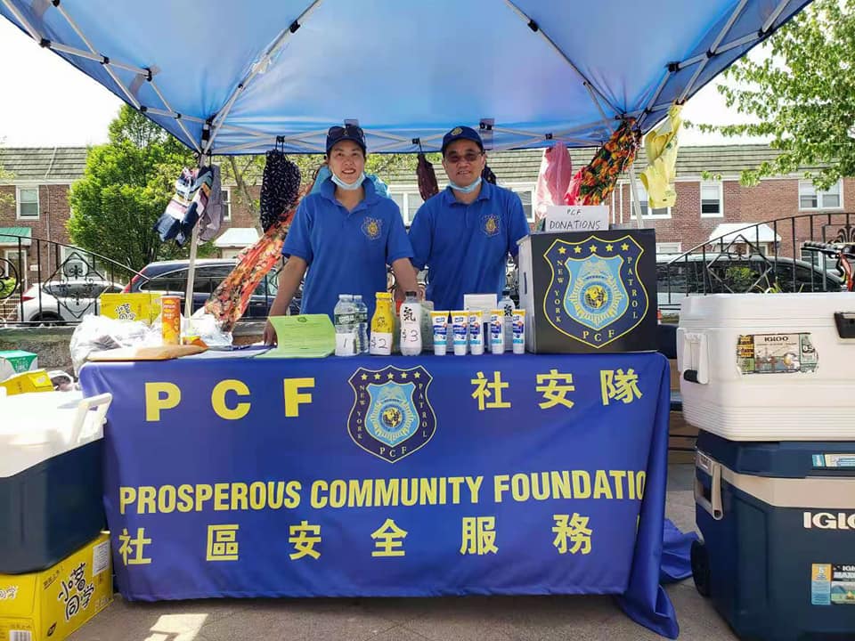 PCF community safety booth with volunteers serving at outdoor community fair
